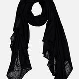 The WHITE + WARREN Superfine Cashmere Blend Travel Wrap, shown in black on a white background, is lightweight with slightly sheer edges—making it the perfect unisex scarf for versatile, all-season style.