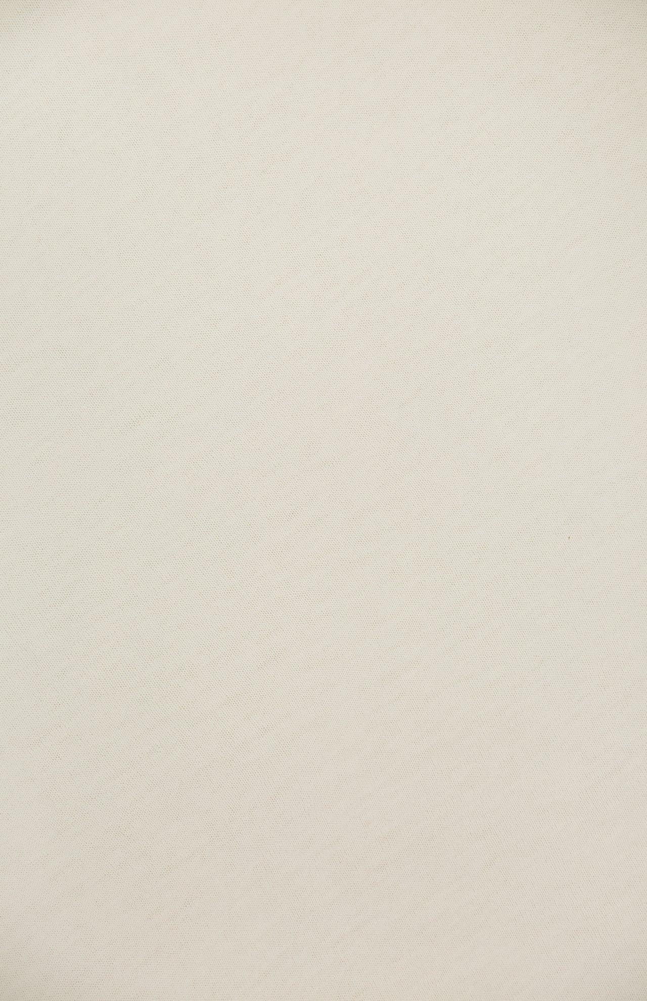 A close-up of the Superfine Cashmere Blend Travel Wrap by WHITE + WARREN shows its light beige, textured fabric with subtle diagonal lines—offering a soft, smooth feel that's perfect as a lightweight layer for all-season styling.