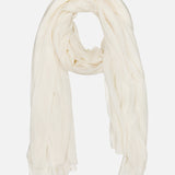 The WHITE + WARREN Superfine Cashmere Blend Travel Wrap is a lightweight, sheer white scarf shown loosely folded on a plain backdrop. Its soft, flowy fabric and gently draped edges make it perfect for all-season styling.