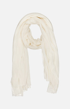 The WHITE + WARREN Superfine Cashmere Blend Travel Wrap is a lightweight, sheer white scarf shown loosely folded on a plain backdrop. Its soft, flowy fabric and gently draped edges make it perfect for all-season styling.