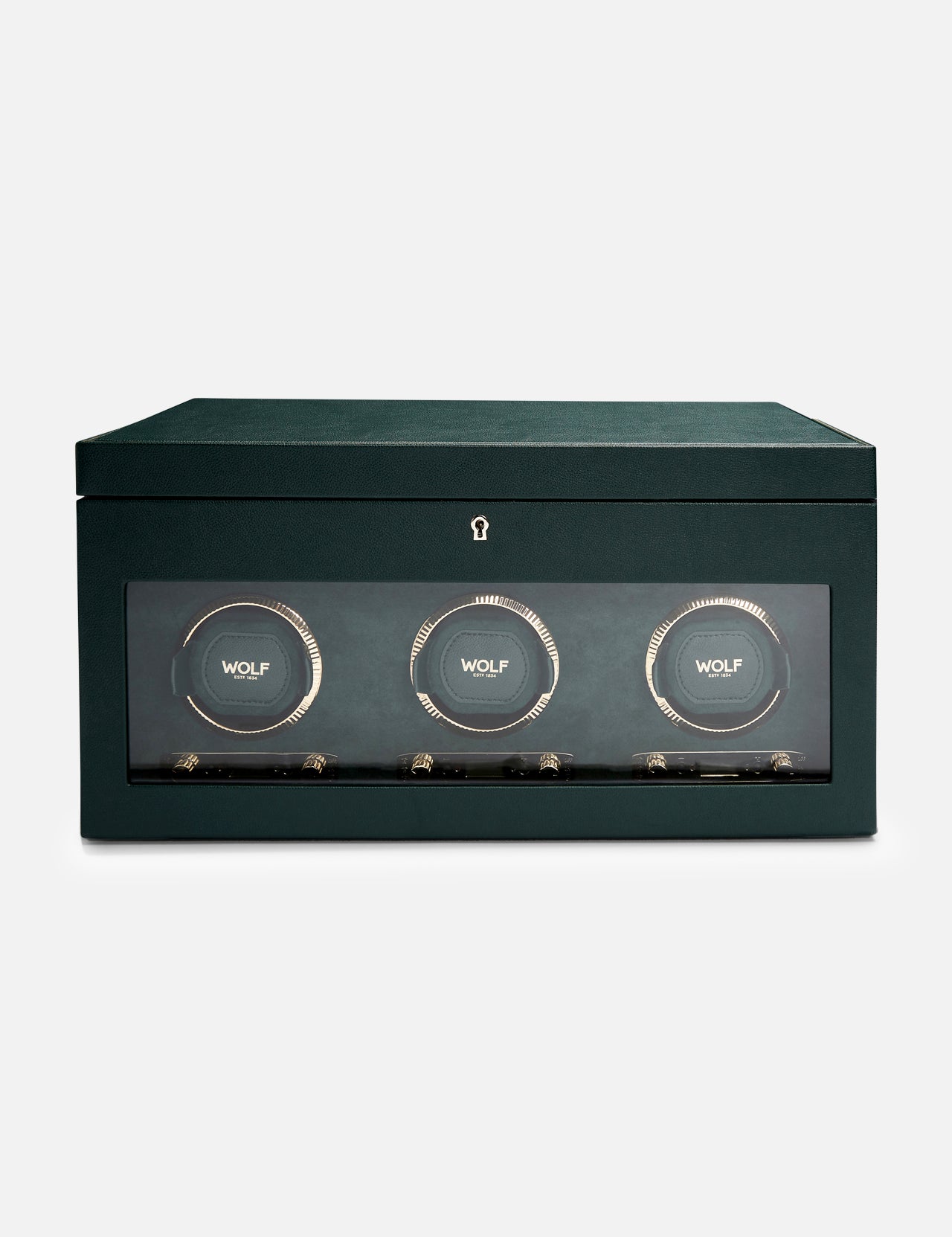 The WOLF British Racing Triple Watch Winder features a green rectangular design with a glass front that showcases three circular compartments, each marked with the WOLF logo. Crafted from premium vegan leather for an elegant and sustainable exterior, this watch winder is designed to wind automatic watches while offering sophisticated storage.