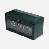 A green British Racing Triple Watch Winder by WOLF crafted from vegan leather, featuring a glass front that displays three wristwatches inside. The box is designed with a lock at the top center and gold-accented watch holders, offering secure and elegant storage for your timepieces.