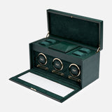 The WOLF British Racing Triple Watch Winder is an elegantly crafted watch winder box made from vegan leather in a dark green hue, lined with velvet. With an open lid display, it features three circular watch winders and offers ample storage space for additional watches and accessories.