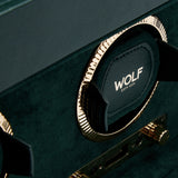 Close-up of the British Racing Triple Watch Winder by WOLF, a luxurious green watch winder with gold accents, crafted from premium vegan leather and featuring the WOLF EST. 1834 branding on one of the holders—an elegant solution for refined watch storage.