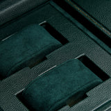 Close-up of the WOLF British Racing Triple Watch Winder’s luxurious green vegan leather interior, featuring two padded watch holders. Each holder is wrapped in soft, green suede and fits securely within its own compartment, offering an elegant and sophisticated solution for watch storage.