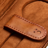 Close-up of the WOLF Brogue 2 Piece Watch Zip Case in brown leather, showcasing visible stitching and a snap closure. The case is open to display its interior compartment and zippered edge, evoking the elegance of a refined watch holder crafted for luxury timepiece storage.