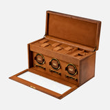 The WOLF Brogue Triple Winder with Storage is a brown leather luxury watch winder box, displayed here with its lid open to showcase a triple watch winder and spacious compartments for additional watch storage. The front panel, featuring a glass window, opens elegantly to reveal the stylish interior.