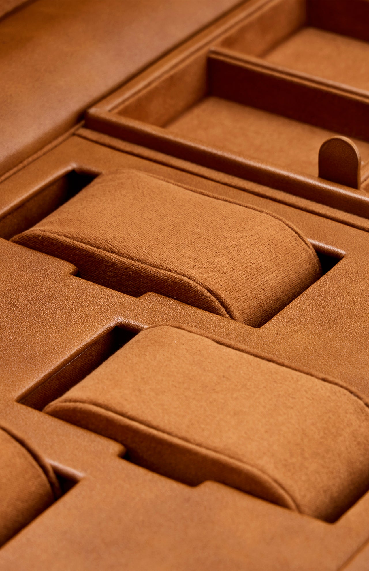 Close-up of the WOLF Brogue Triple Winder with Storage—an elegant brown suede or leather jewelry and watch box featuring multiple compartments and cushioned sections for organizing your collection, perfect for pairing with a luxury triple watch winder.
