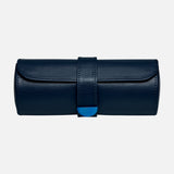 The WOLF Earth Triple Watch Roll is a navy blue cylindrical case crafted from premium apple leather, featuring a flap and strap closure with a subtle blue accent on the front. This stylish accessory provides secure storage for your watches and is photographed against a plain white background.