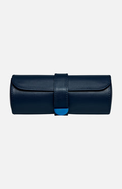 The WOLF Earth Triple Watch Roll is a navy blue cylindrical case crafted from premium apple leather, featuring a flap and strap closure with a subtle blue accent on the front. This stylish accessory provides secure storage for your watches and is photographed against a plain white background.