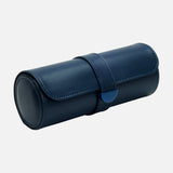 The WOLF Earth Triple Watch Roll is a cylindrical watch roll crafted from navy blue apple leather, featuring a snap closure and designed for storing items like watches or jewelry. It is shown against a plain light gray background.