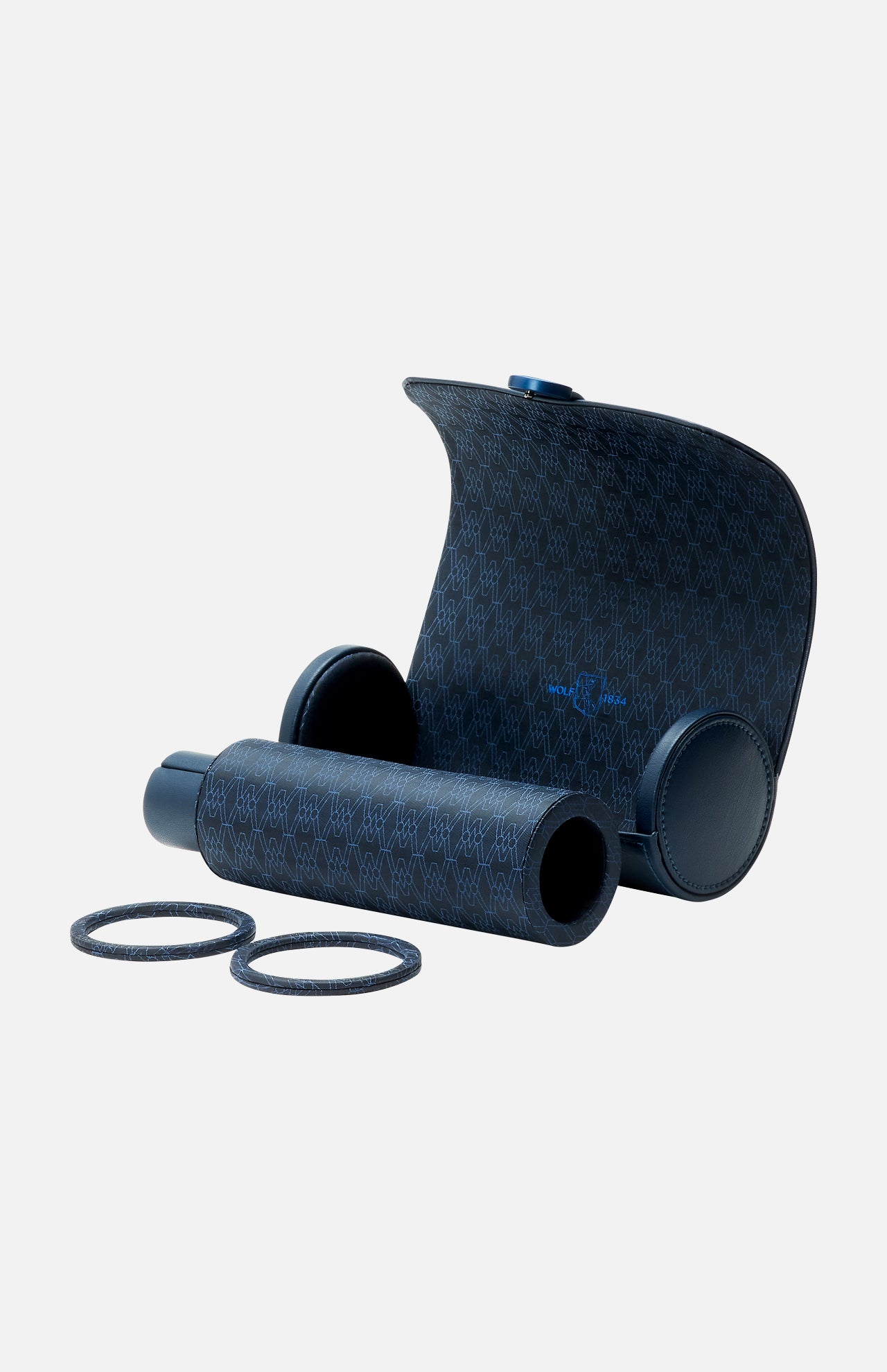 A dark blue WOLF Earth Triple Watch Roll, adorned with a subtle monogram pattern inspired by luxury watch rolls, is presented on a light background alongside a matching protective cover and two additional refill rolls.