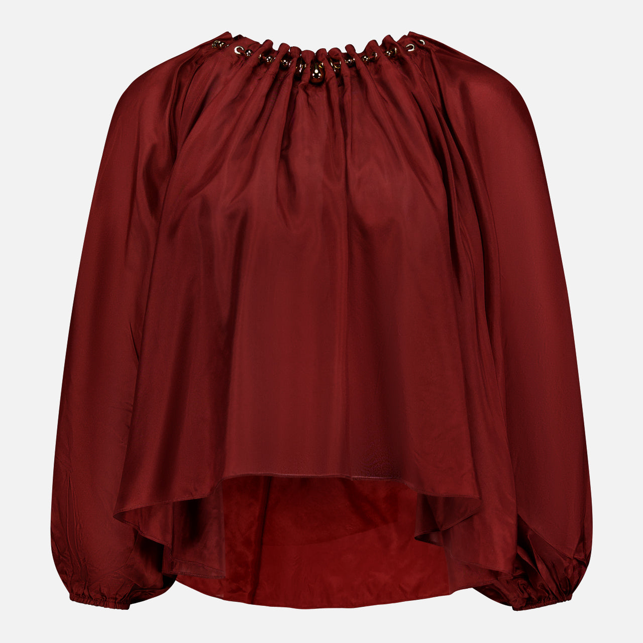 The ZIMMERMANN Aster Gathered Bead Blouse is a loose-fitting, long-sleeve bohemian top in dark red, featuring a grommet-detailed neckline and flowy asymmetrical hem, shown against a plain white background.