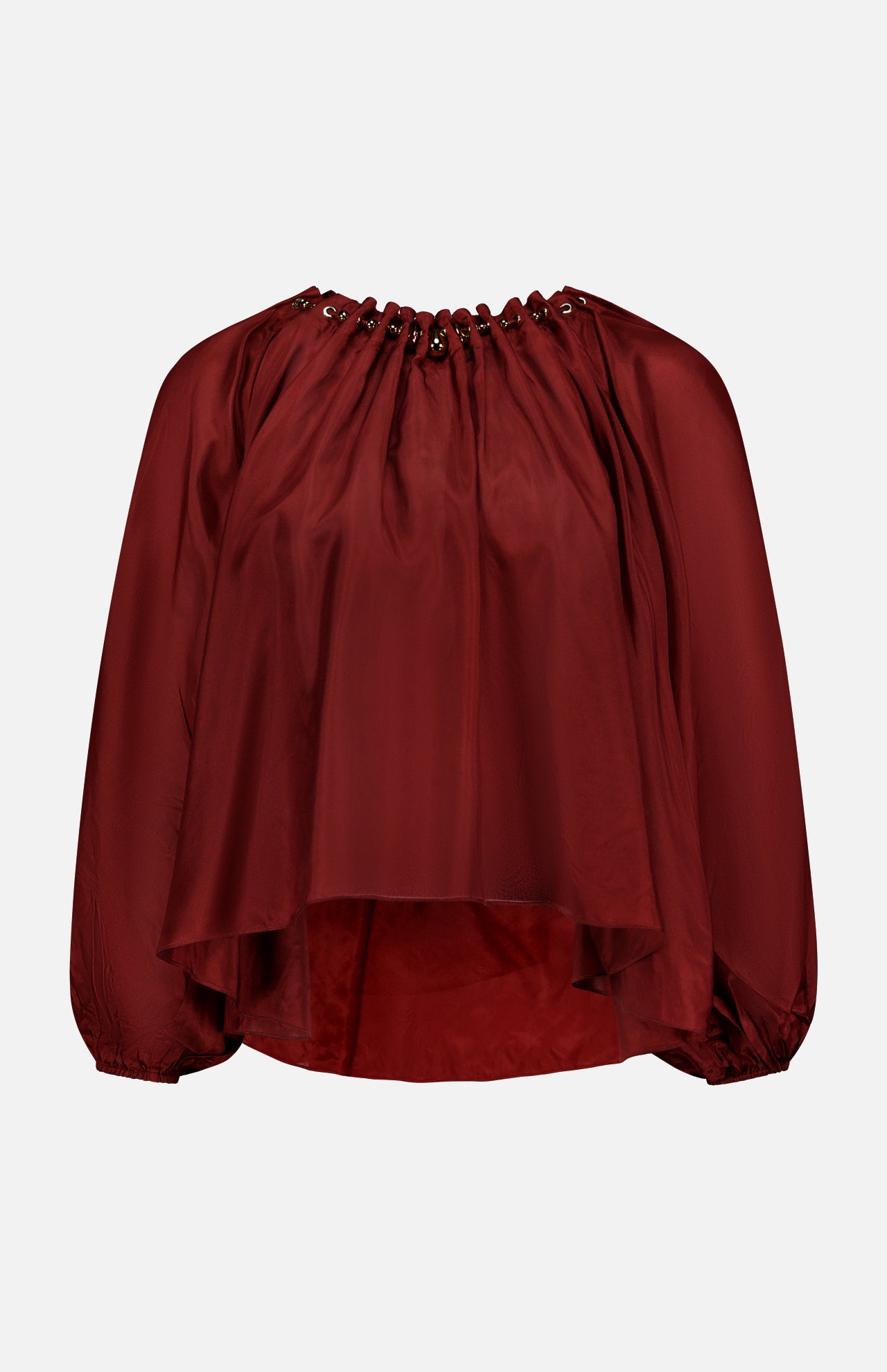 The ZIMMERMANN Aster Gathered Bead Blouse is a loose-fitting, long-sleeve bohemian top in dark red, featuring a grommet-detailed neckline and flowy asymmetrical hem, shown against a plain white background.