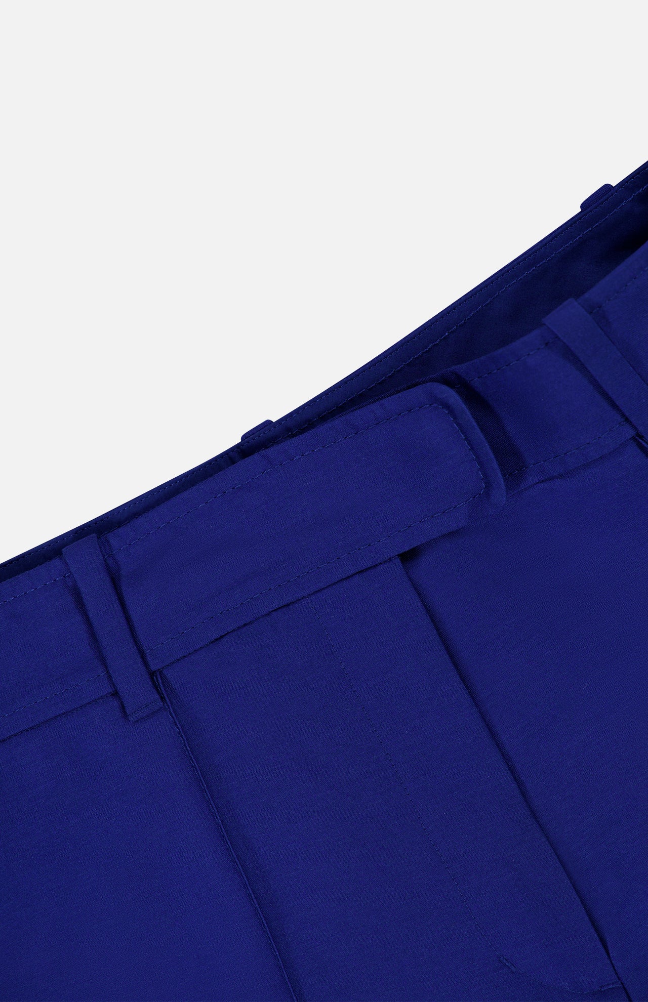 Close-up of the cobalt blue waistband and belt loops of Zimmermann Clash Wool Silk Flare Trouser Pants.