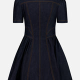 The ZIMMERMANN Denim Corset Mini Dress features a dark denim finish with short puffed sleeves, a fitted waist, and a flared skirt accentuated by visible brown stitching. The back view showcases detailed seams and corset-style structure, creating a tailored and sophisticated appearance.