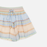 The Indra Stripe Drawstring Short by ZIMMERMANN features pastel blue, orange, green, and beige stripes on lightweight fabric. It has a mid rise, jeweled front drawstring waist, and a flared hem with decorative beads.