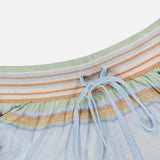 Close-up of the ZIMMERMANN Indra Stripe Drawstring Short in light blue with horizontal pastel stripes, ribbed waistband, jeweled drawstring, and mid-rise silhouette.