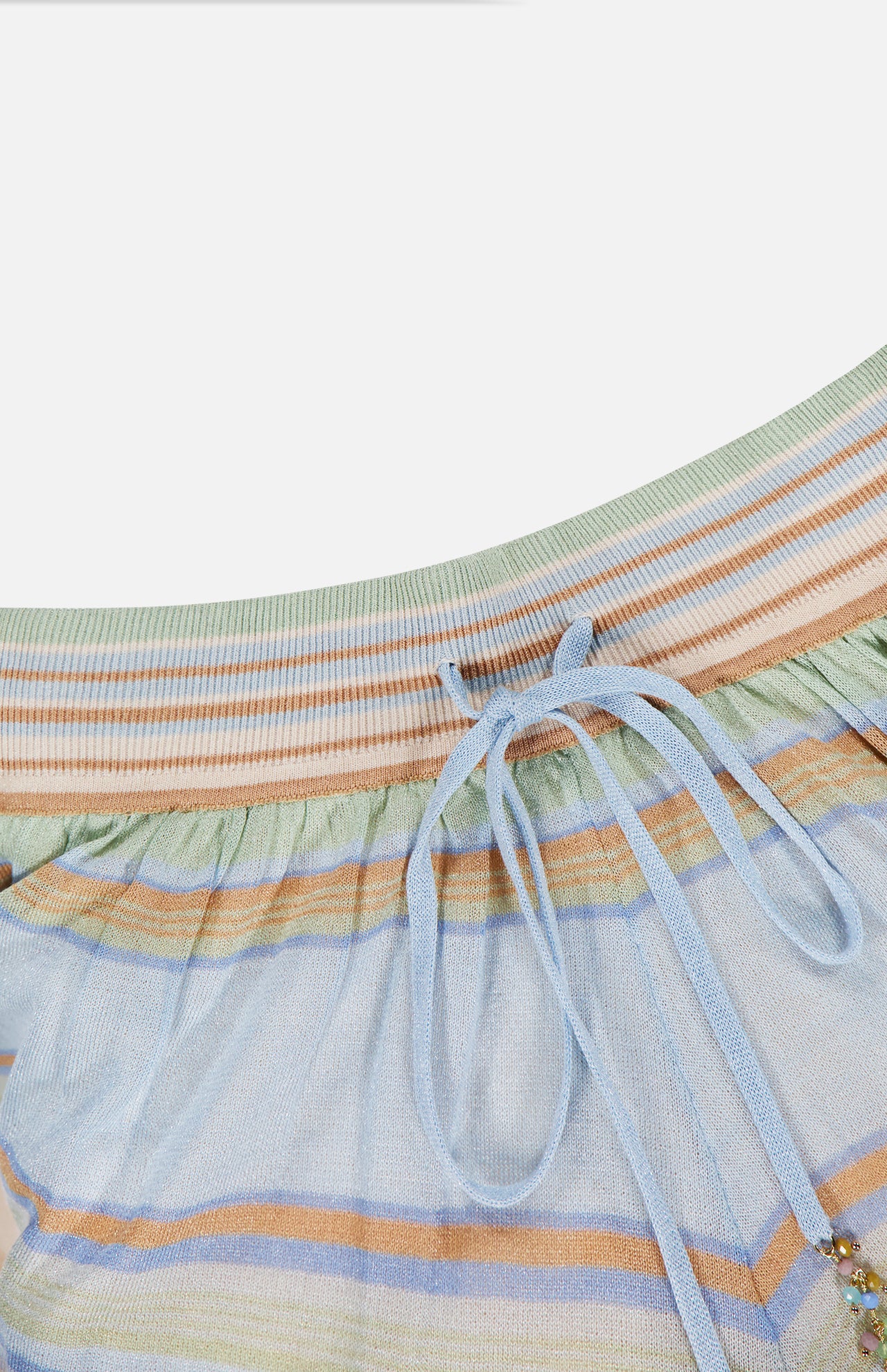 Close-up of the ZIMMERMANN Indra Stripe Drawstring Short in light blue with horizontal pastel stripes, ribbed waistband, jeweled drawstring, and mid-rise silhouette.