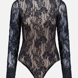 The ZIMMERMANN Stretch Lace Bodysuit features a black long-sleeve design crafted from sheer stretch lace with delicate floral patterns, a round neckline, and a fitted silhouette, showcased against a plain white background.