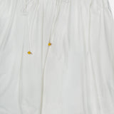 Brighten up your look with the Mahon Embroidered Midi Skirt by ZIMMERMANN. This ivory cotton skirt features an elastic waistband with a drawstring and yellow beads, plus delicate cutout embroidery at the hem.