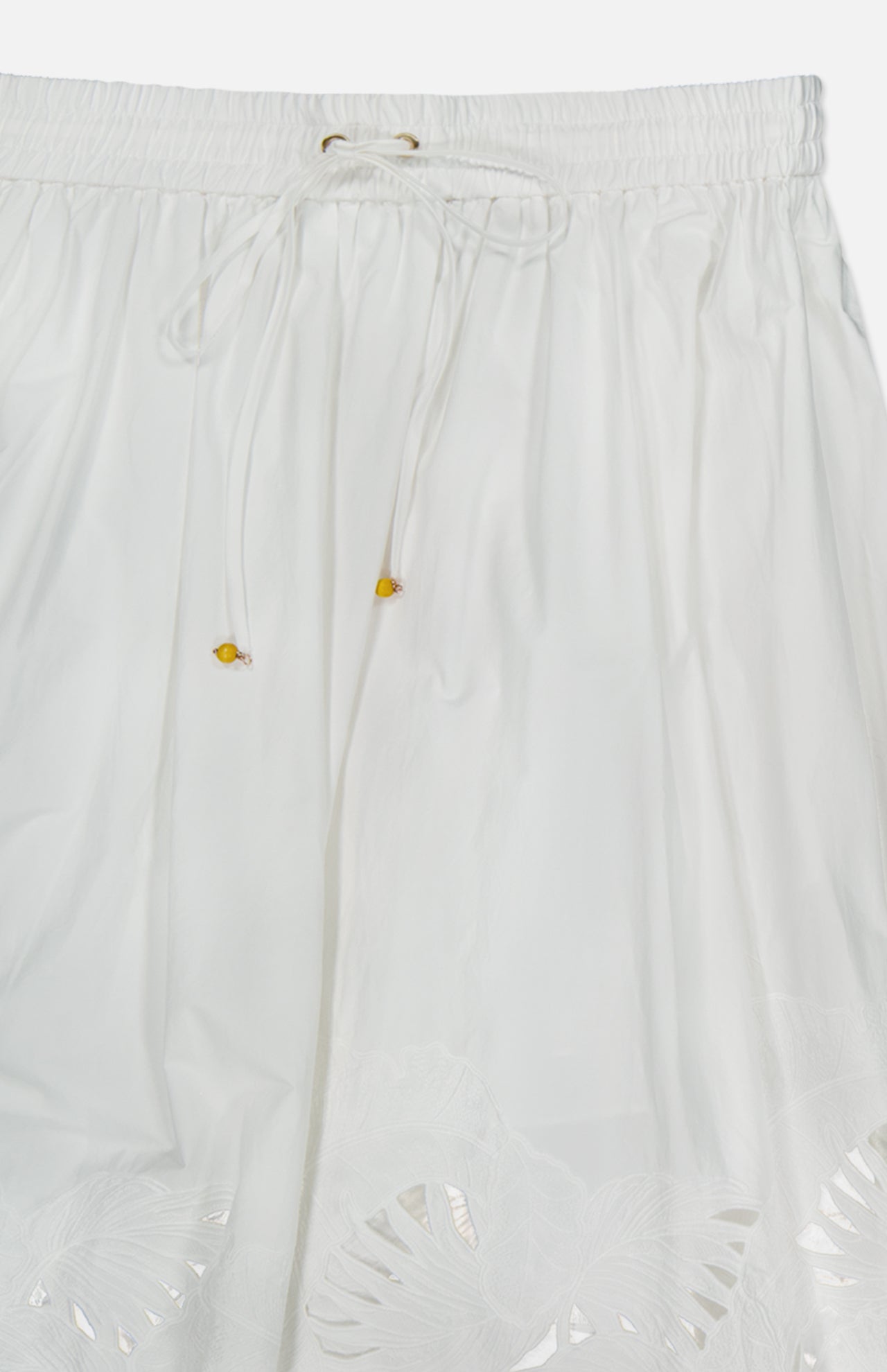 Brighten up your look with the Mahon Embroidered Midi Skirt by ZIMMERMANN. This ivory cotton skirt features an elastic waistband with a drawstring and yellow beads, plus delicate cutout embroidery at the hem.