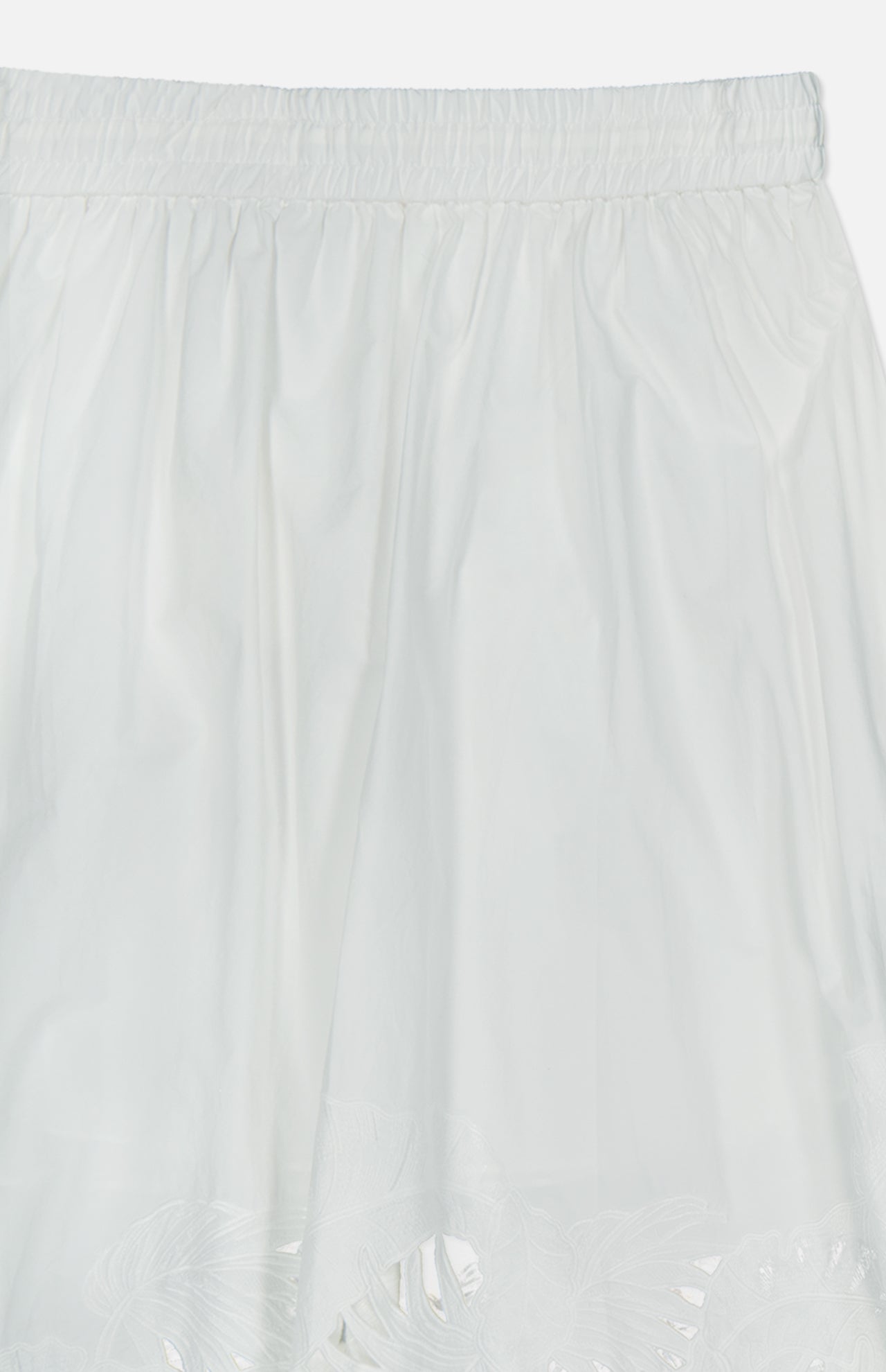 The ZIMMERMANN Mahon Embroidered Midi Skirt features an elastic waistband, delicate embroidery near the hem, and a lightweight, slightly sheer ivory fabric—making it an ideal choice for summer.