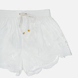The ZIMMERMANN Mahon Embroidered Drawstring Short features an ivory high-rise design, scalloped hem, elastic waistband with gold-accented drawstring, and delicate leaf embroidery on cotton.