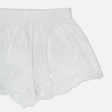 The Mahon Embroidered Drawstring Short by ZIMMERMANN features white, semi-sheer high-rise shorts with an elastic waistband and delicate embroidery along the scalloped hem, shown on a plain white background.