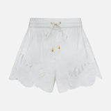 The ZIMMERMANN Mahon Embroidered Drawstring Short features an ivory hue, gold bead accents, and leaf-patterned cutouts along the scalloped hem. Made from cotton, these high-rise shorts are shown against a plain white background.