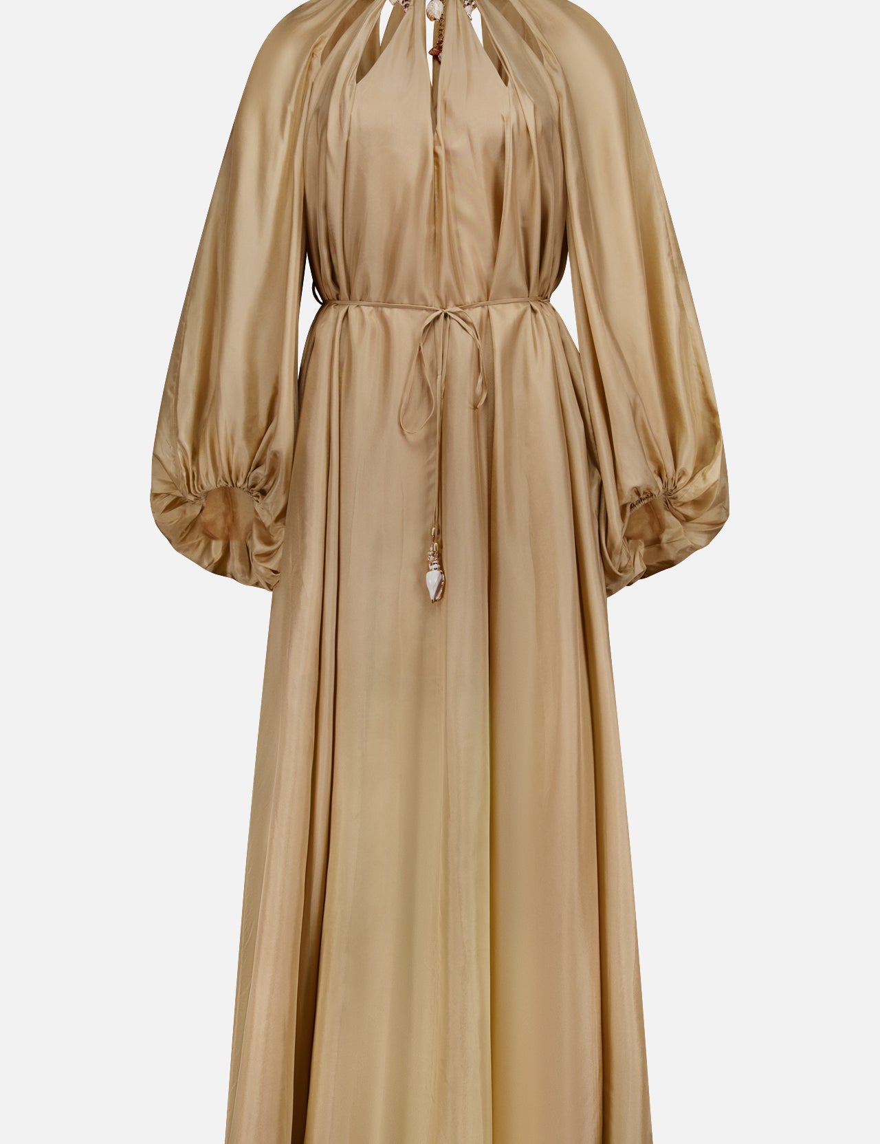 The Mahon Shell Charms Maxi Dress by ZIMMERMANN is a long-sleeved gold silk habutae dress with a cinched waist, gathered neckline, full billowy sleeves, keyhole neck detail, and tasseled waist tie.