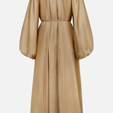 The ZIMMERMANN Mahon Shell Charms Maxi Dress is a long, champagne gown with voluminous puffed sleeves, a high neckline, keyhole back, and delicate seashell charms, shown on a plain white background.
