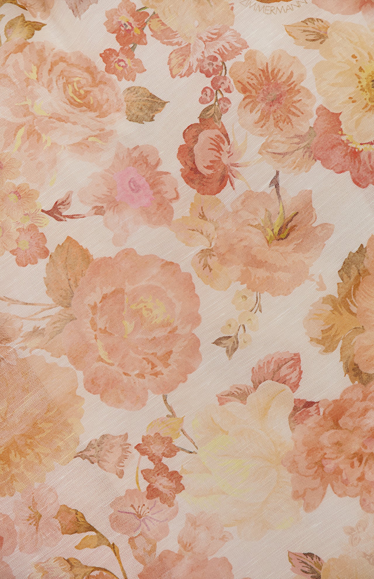 The ZIMMERMANN Rebellion Drape Floral Midi Dress features a soft, vintage-style pattern with large watercolor flowers in pink, peach, and yellow on a light background—ideal for a timeless, feminine look.