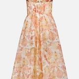The ZIMMERMANN Rebellion Drape Floral Midi Dress is a sleeveless, vintage-inspired silk-linen organza A-line dress with a fitted bodice, gathered peach and gold floral skirt, wide straps, and a subtle sweetheart neckline.