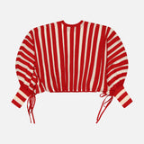 The ZIMMERMANN Rebellion Drawn Cuff Sweater is a red and cream striped, cropped sweater with long blouson sleeves and adjustable cuff ties, shown against a white background.