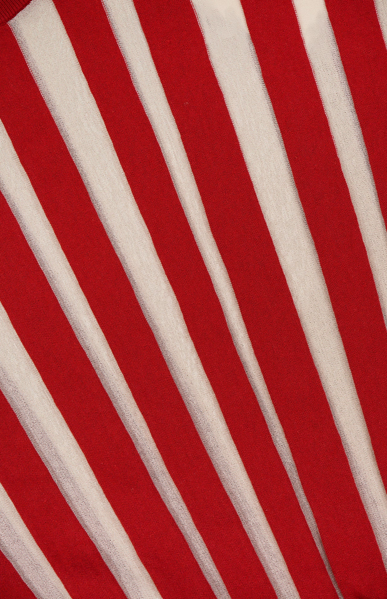 The ZIMMERMANN Rebellion Drawn Cuff Sweater features a bold, cropped fit with dynamic, diagonal red and cream stripes for a visually striking look.