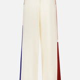 Zimmermann Stripe Relaxed Pant in off-white silk-blend, featuring a straight-leg silhouette with vertical blue, pink, and burgundy color-block stripes on the outer seams.