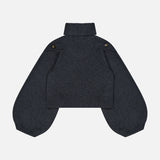 The Valiant Buttoned Sweater by ZIMMERMANN is a dark gray, cropped knit turtleneck featuring ribbed cuffs and hem, puffed long sleeves, and distinctive button details on the shoulders. This statement piece is shown laid flat against a plain white background.