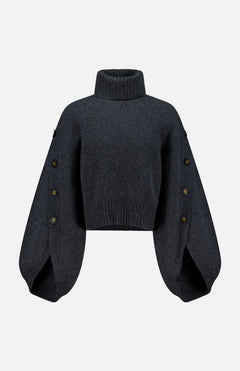 The Valiant Buttoned Sweater by ZIMMERMANN is a dark gray cropped turtleneck with a high neckline and wide, balloon sleeves adorned with button details along the outer seams. Displayed against a plain white background, this statement piece blends modern design and cozy comfort—making it an eye-catching addition to your sweater collection.
