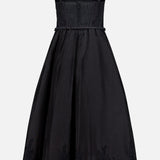 The Valiant Lace Trim Midi Dress by ZIMMERMANN showcases a sleeveless silhouette with lace-trimmed straps, a fitted corset-style bodice, and a slender belt accentuating the waist. Finished with delicate lace detailing along the hem of the full skirt, this elegant black dress is a stunning choice for those seeking refined style and timeless sophistication.