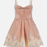 The Valiant Lace Trim Mini Dress by ZIMMERMANN features a pink sleeveless linen-silk design with delicate cream-colored lace accents at the hem and bust. With its fitted bodice, spaghetti straps, and flared skirt, this romantic mini dress exudes a delicate and enchanting charm.