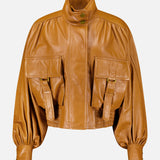 Zimmermann Valiant Leather Biker Jacket in amber, featuring a high collar, puffed sleeves, and two large front flap pockets with buckle straps.