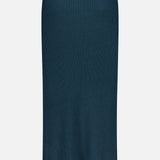 ZIMMERMANN’s Valiant Merino Straight Midi Skirt, featuring a dark teal hue, ribbed knit merino wool construction, straight silhouette, elastic waistband, and minimal design, is displayed on a plain white background.