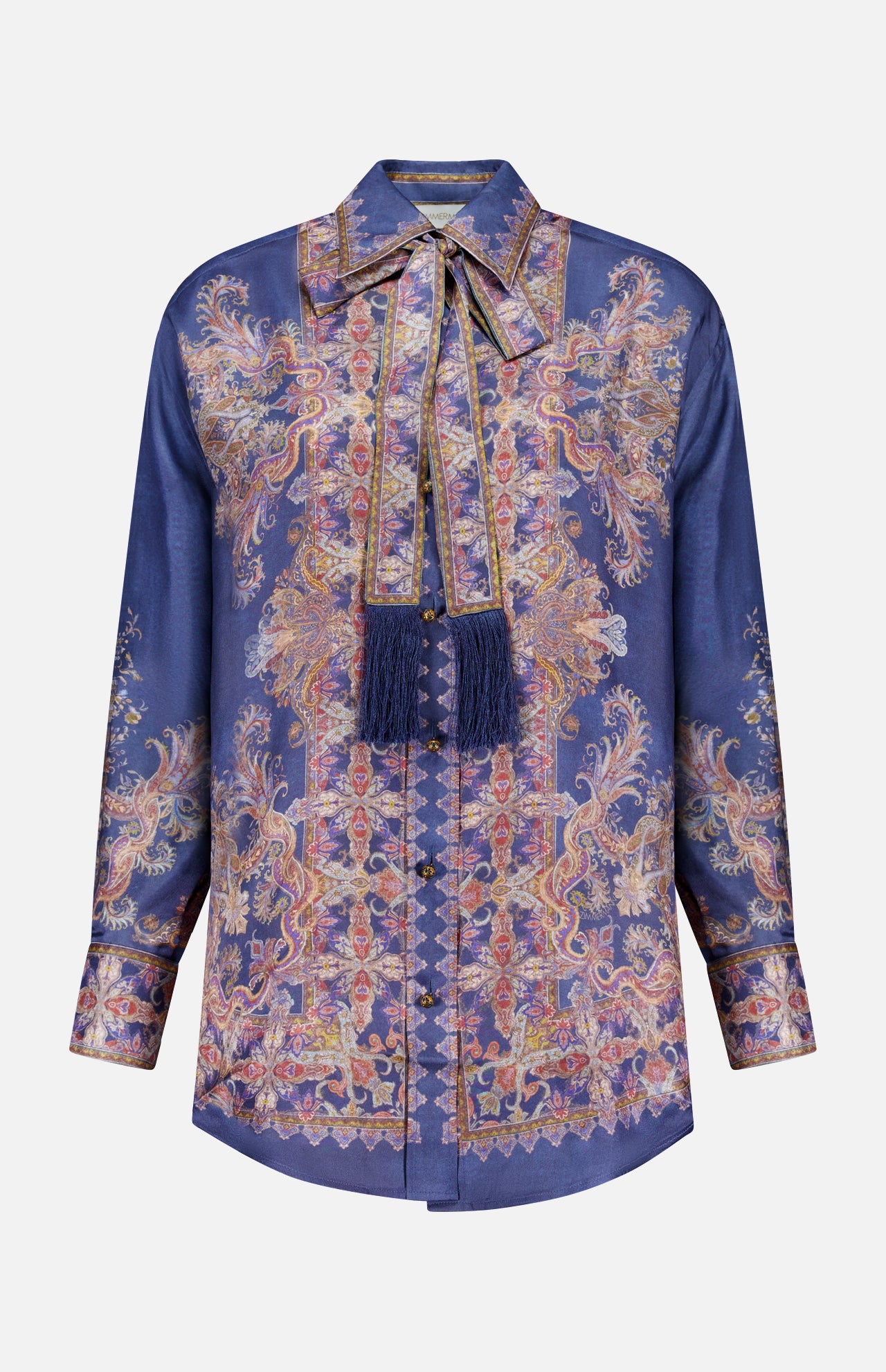 The ZIMMERMANN Valiant Relaxed Bow Collar Shirt is a long-sleeve, button-up silk blouse in deep blue, featuring an ornate gold and pink paisley pattern and a matching bow collar necktie embellished with fringed tassels—offering the perfect blend of designer women’s shirt elegance and subtle bohemian charm.