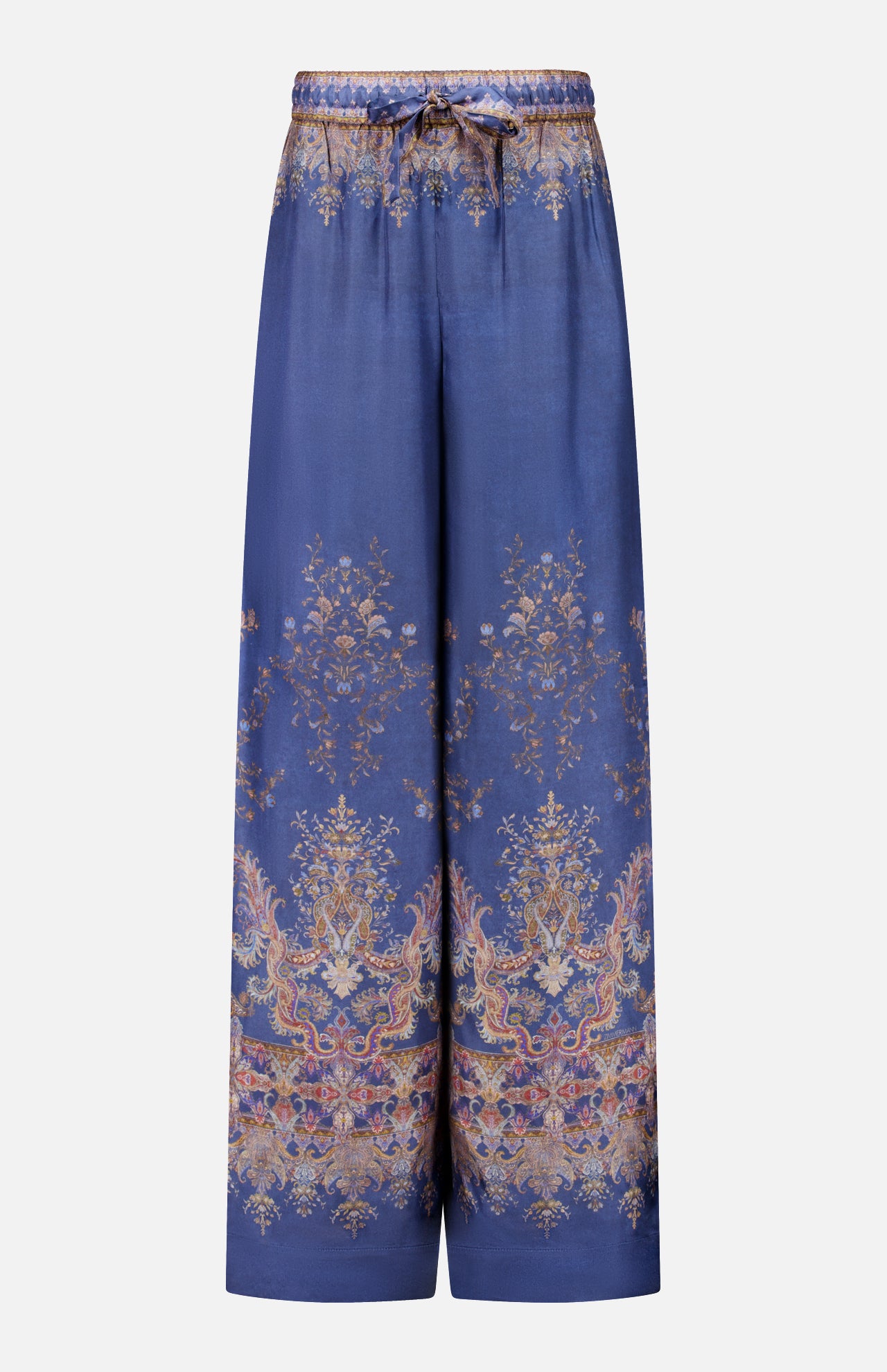 The Valiant Paisley Print Track Pant by ZIMMERMANN features a wide-leg silhouette in silky blue fabric, adorned with an ornate gold and pink paisley floral pattern. These high-rise pull-on pants include an elastic waistband with a drawstring tie, and showcase intricate, symmetrical detailing at both the hem and waist.