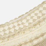 Close-up of the ZIMMERMANN Wanderlust Crochet Midi Skirt, featuring cream, gold, and metallic threads with braided, fringed, and textured horizontal patterns—crocheted design set against a white background.