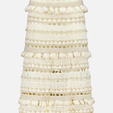 The Wanderlust Crochet Midi Skirt by ZIMMERMANN is a cream-colored, high-waisted midi with textured horizontal patterns, decorative loops for a layered 3D look, a fitted silhouette, and a subtly flared hem.