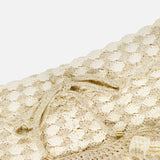 Close-up of ZIMMERMANN’s Wanderlust Crochet Short in cream and gold, featuring a textured scallop pattern and a matching drawstring with gold-tipped ends—perfect for adding elegant flair to your summer look.