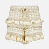 The ZIMMERMANN Wanderlust Crochet Short features a cream hue, high waist, textured crochet pattern, ruffled hems and sides, plus a drawstring waist—perfect summer shorts shown on a plain white background.