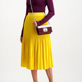 Full Body Image Of Model Wearing Alice & Olivia Ken Pleated Midi Skirt (3925354774643)